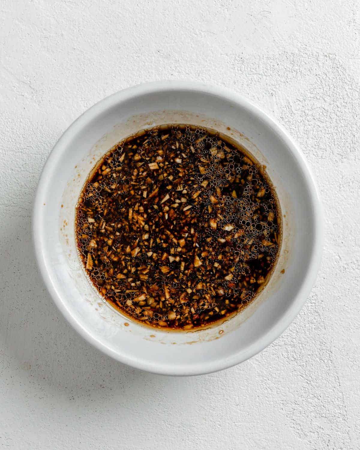 sauce for Sesame Soba Noodles in a white bowl against a white background