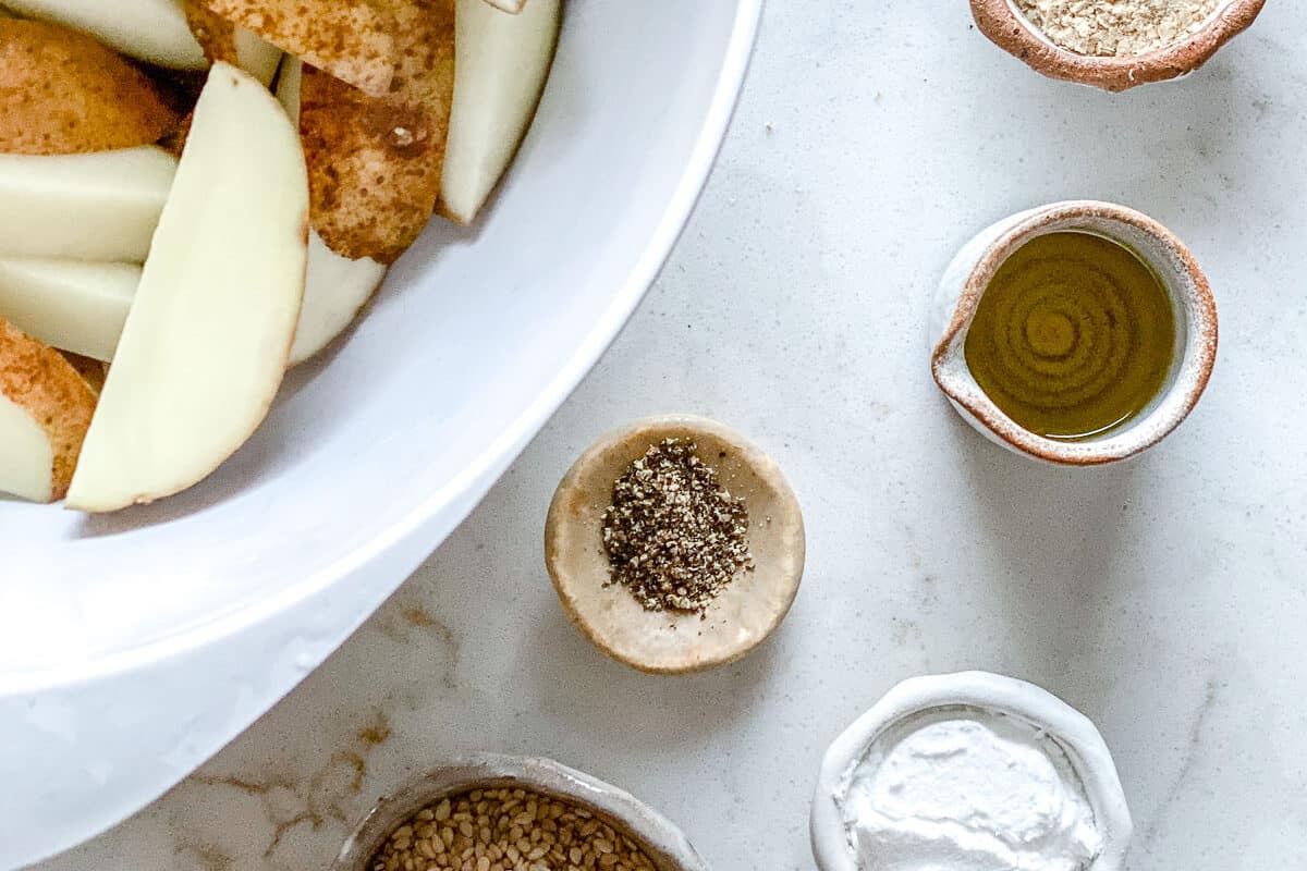 ingredients for oven baked sesame fries against a white surface