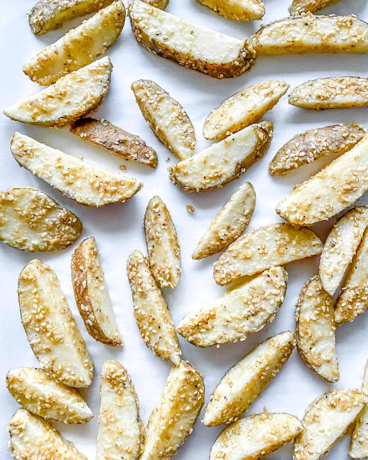seasoned uncooked sesame fries on baking tray
