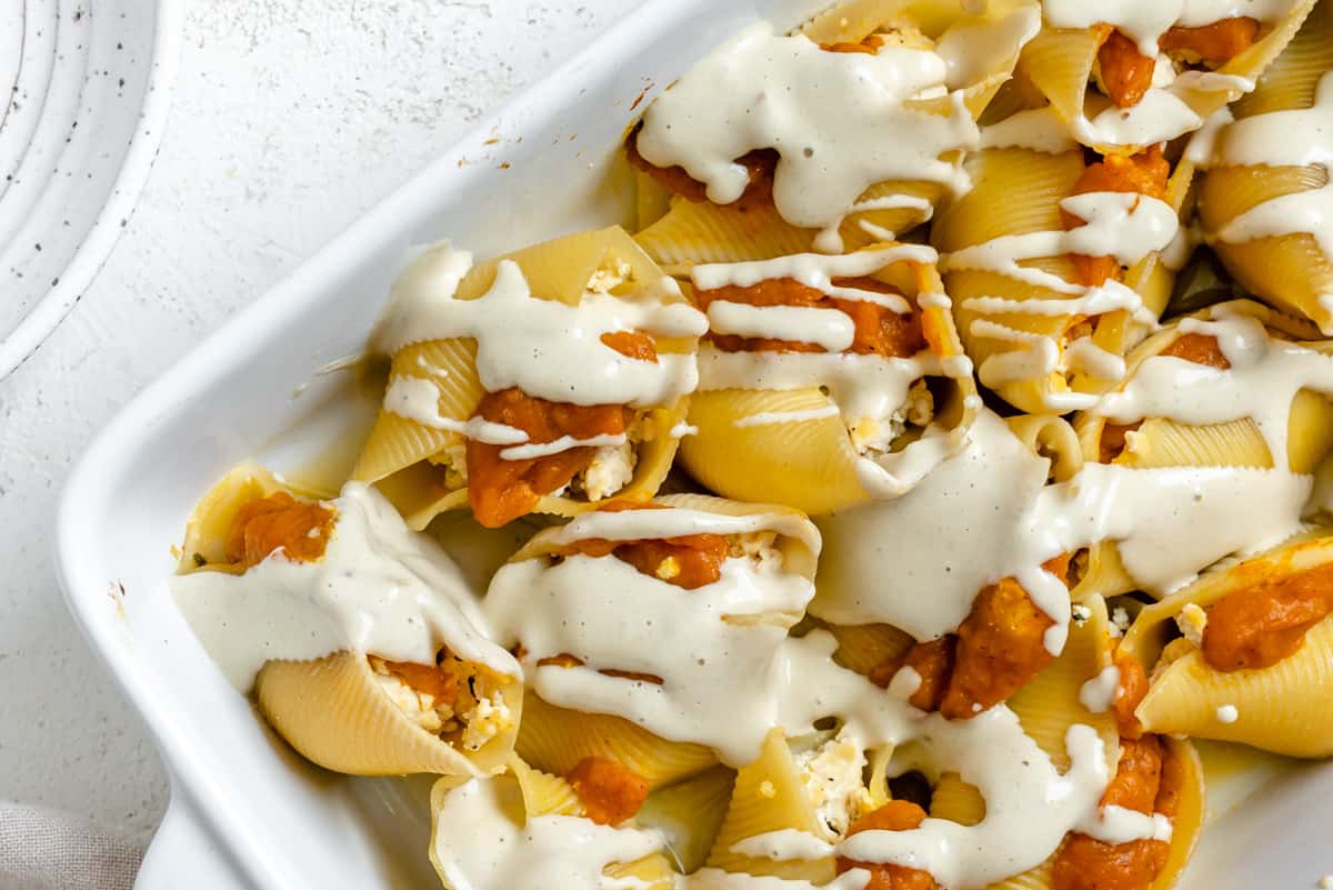 completed Pumpkin Stuffed Shells With Sage Cream in a white baking tray