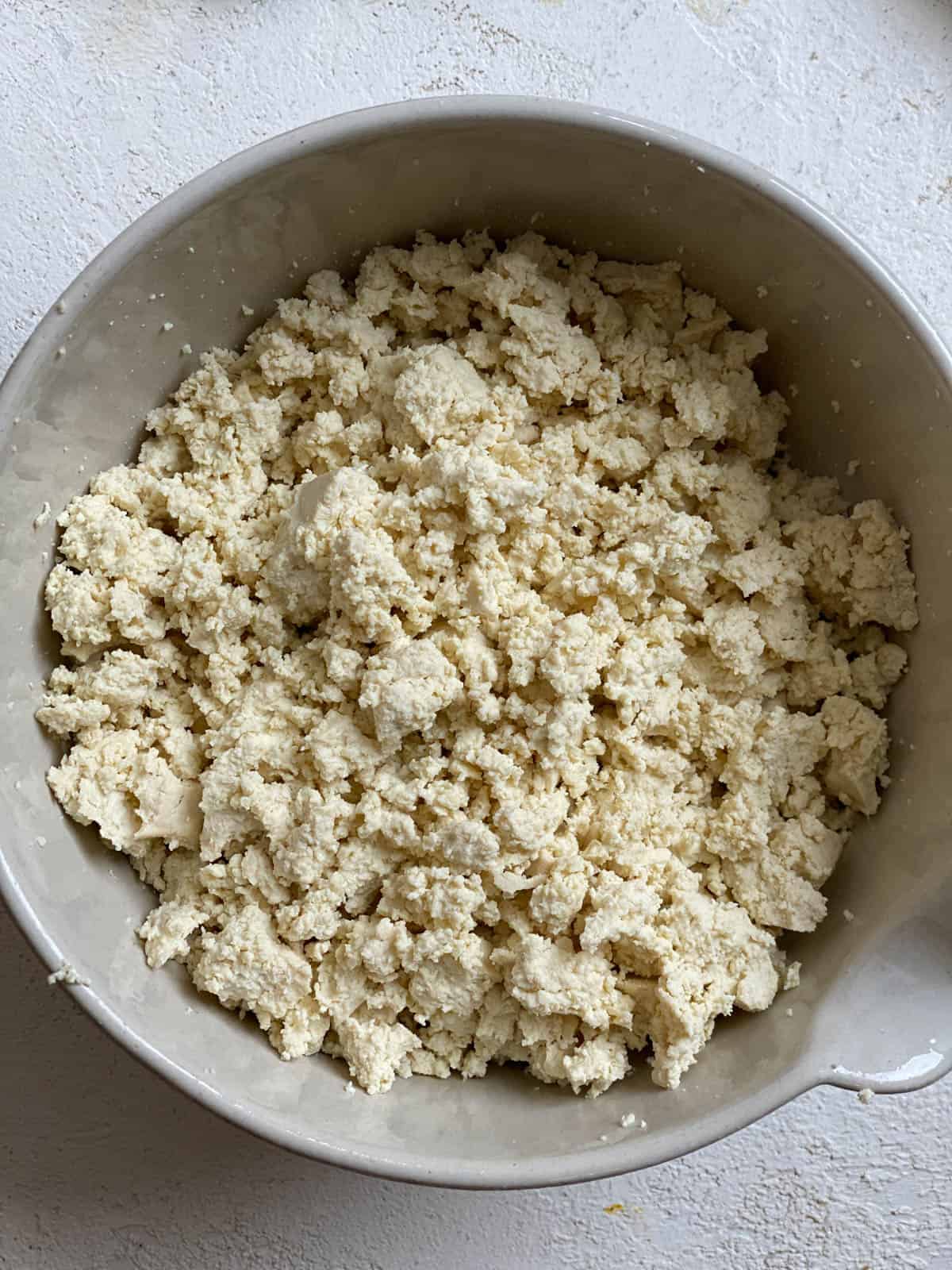 crumbled tofu in a bowl against a white surface