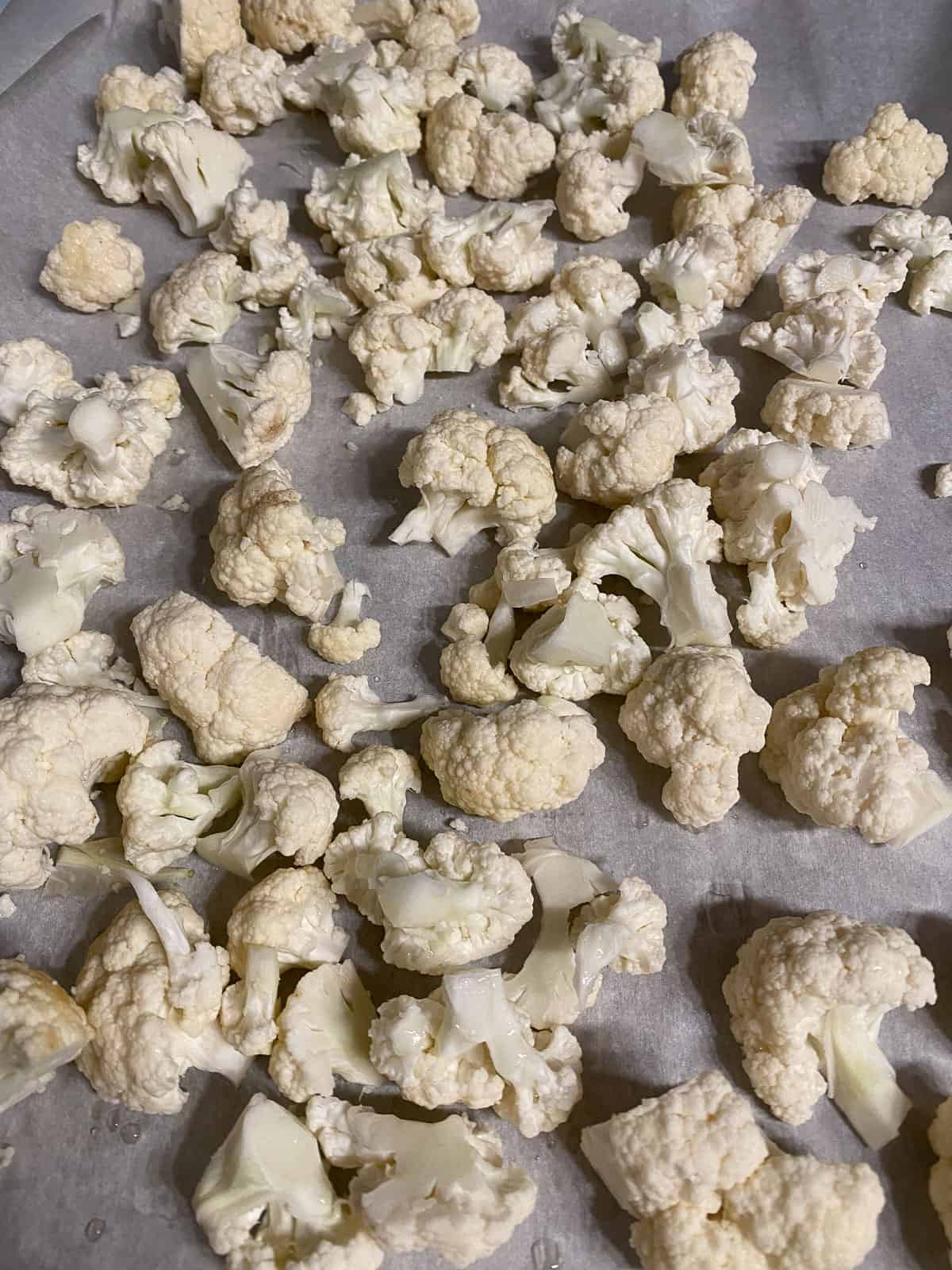 several cauliflower florets on a baking sheet