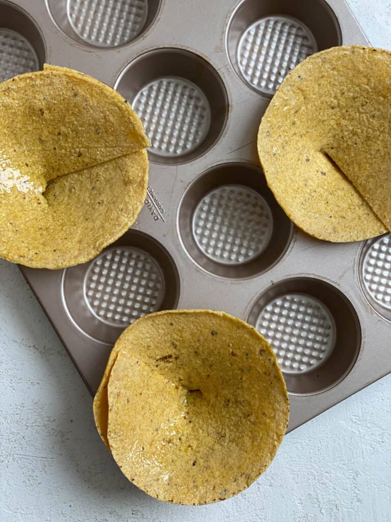 process of adding tortillas to muffin tin