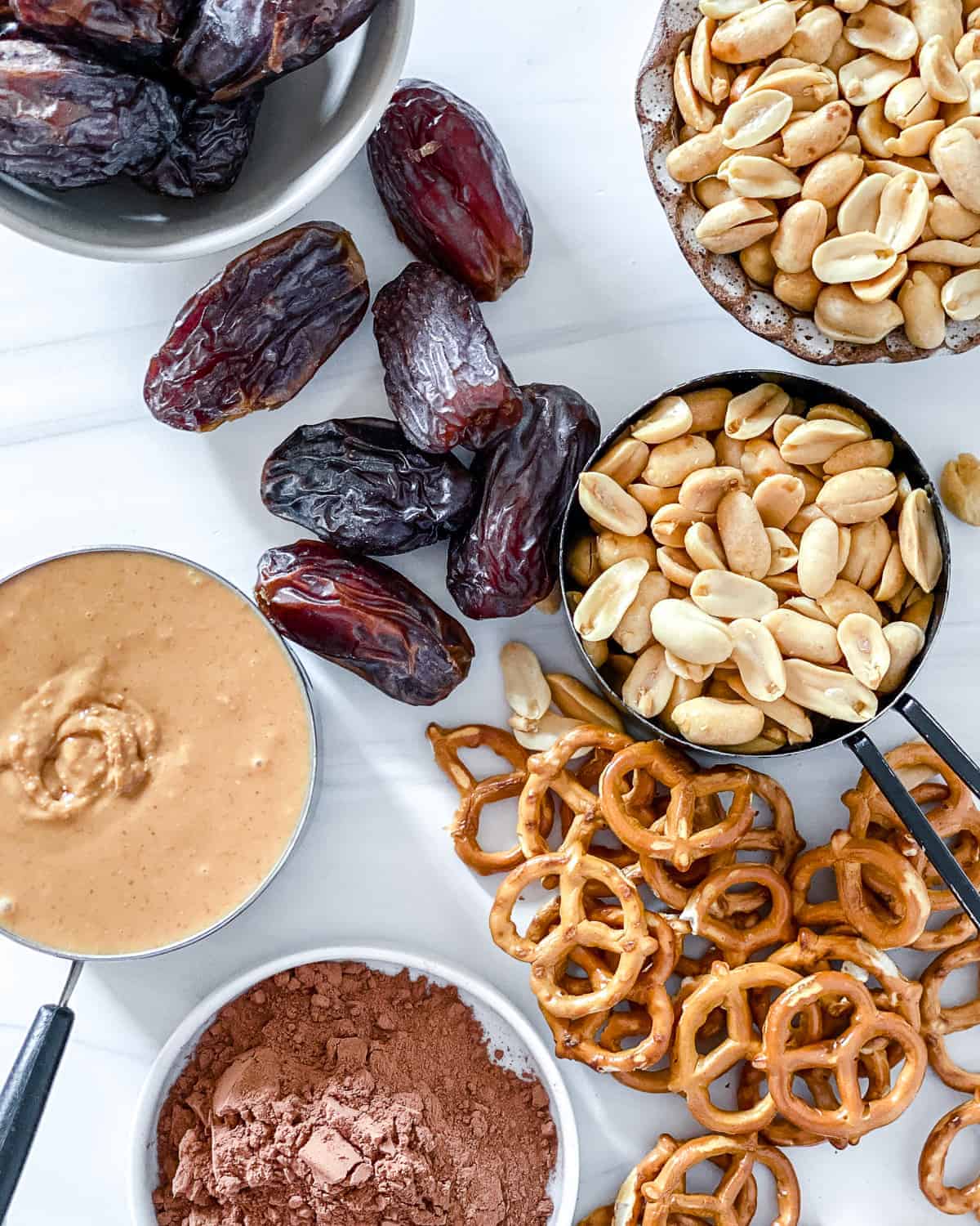 ingredients for Easy Chocolate Peanut Butter Pretzel Bars against a white surface