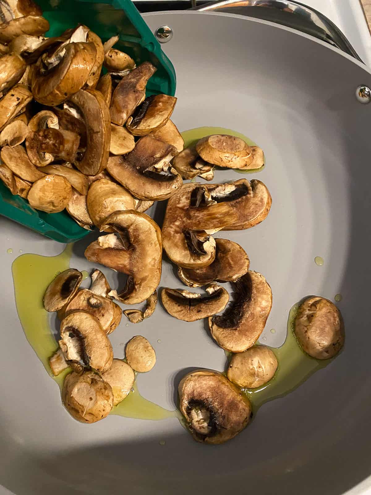 process shot of mushrooms cooking in pan