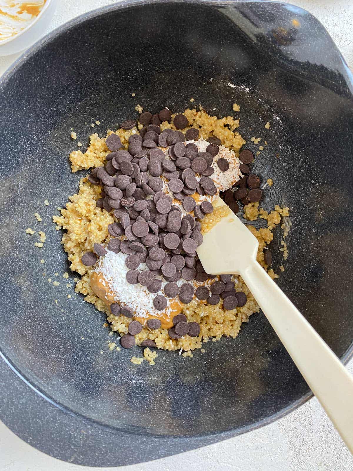 process shot of mixing Vegan Chocolate Chip Quinoa Cookies ingredients in a bowl