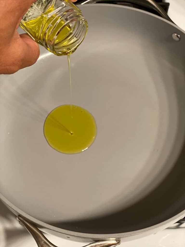 process shot of adding oil to a pan