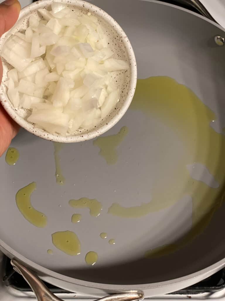 process shot of adding onion to a pan