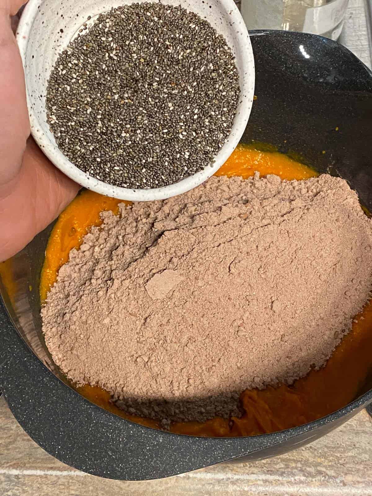process shot of adding chia seeds to sweet potato mixture