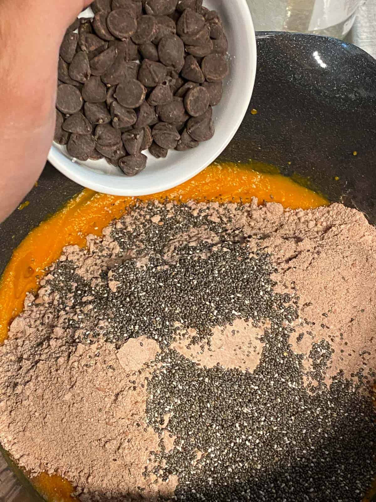 process shot of adding chocolate chips to sweet potato mixture