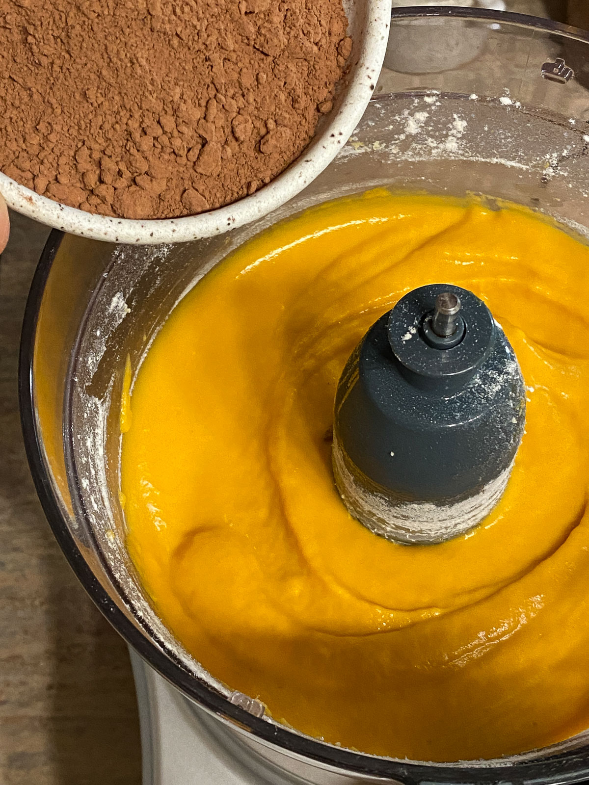 process of adding cocoa into Sweet Potato Brownies mixture in food processor