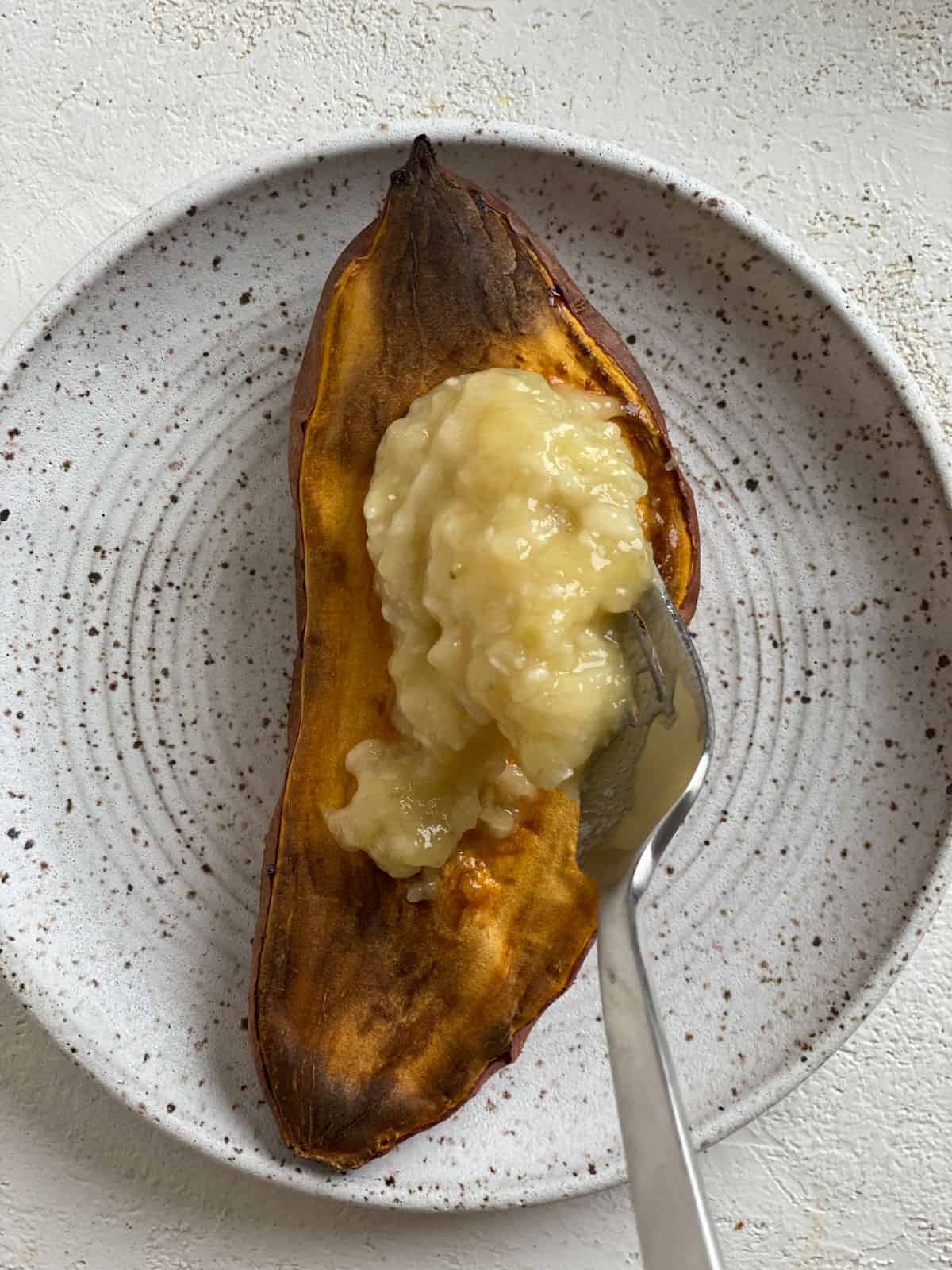 process shot of adding banana to sweet potato on plate