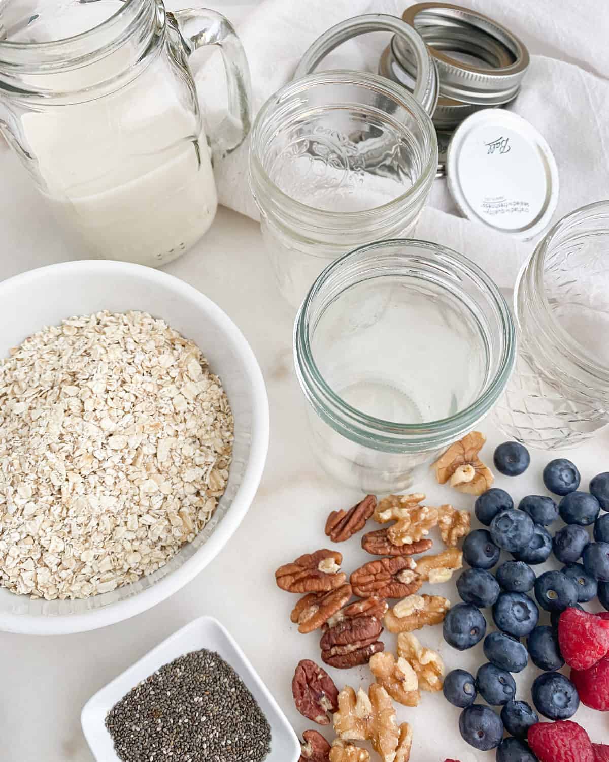 ingredients of overnight oats against a white surface