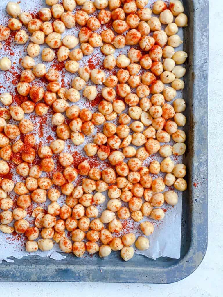 mixing of chickpeas and spices in baking tray