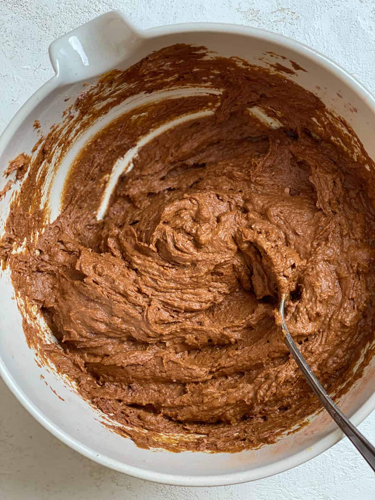 process shot of mixing Easy Pumpkin Brownies together in a bowl
