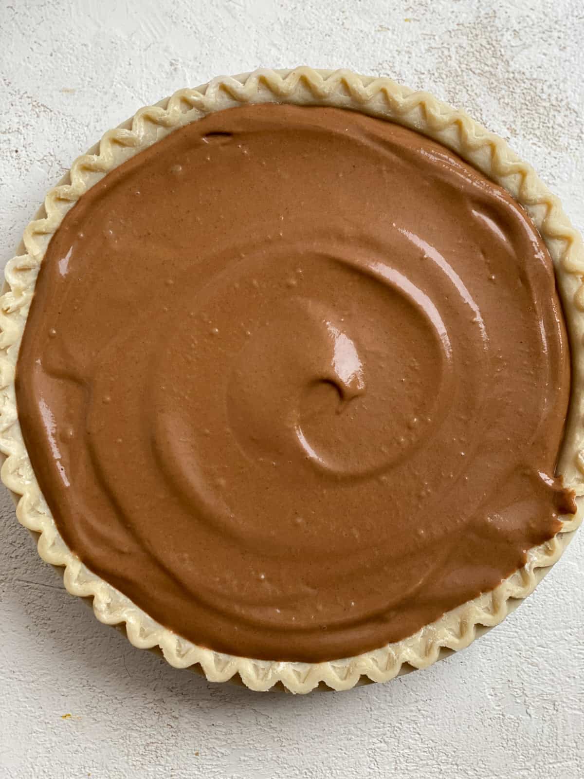 completed Chocolate Pumpkin Pie against a white surface