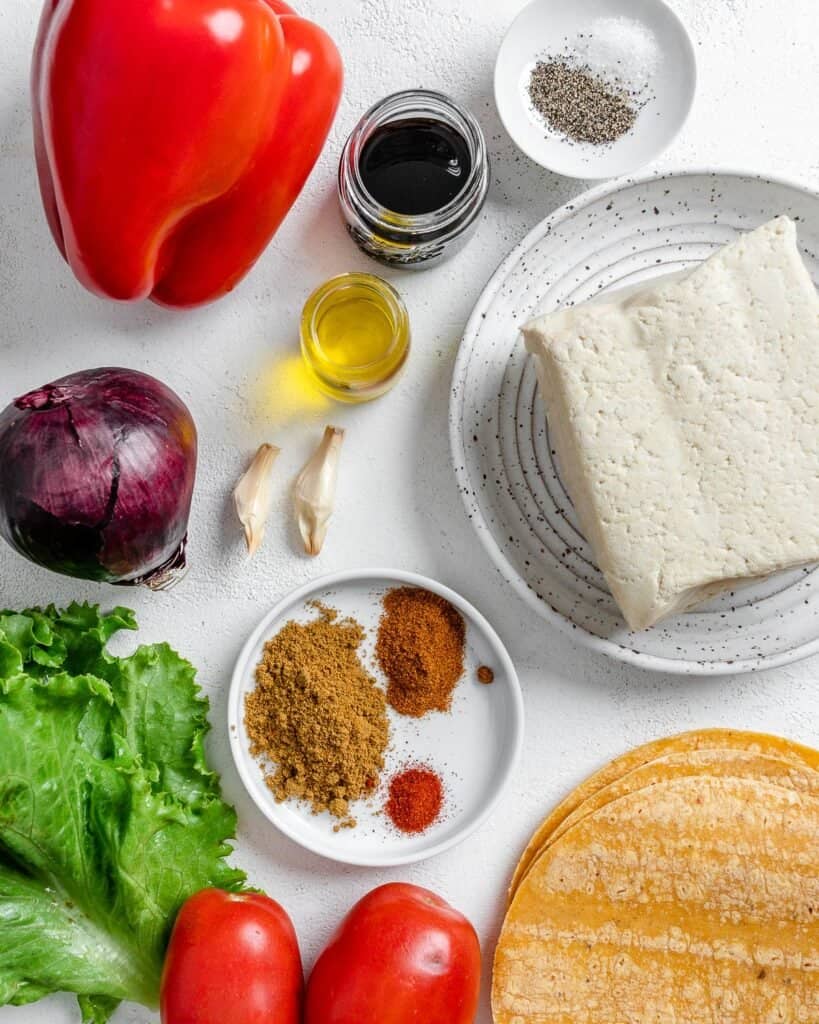 ingredients for tofu tacos measured out on a white surface