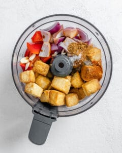 process shot of tofu taco filling in food processor against a white surface