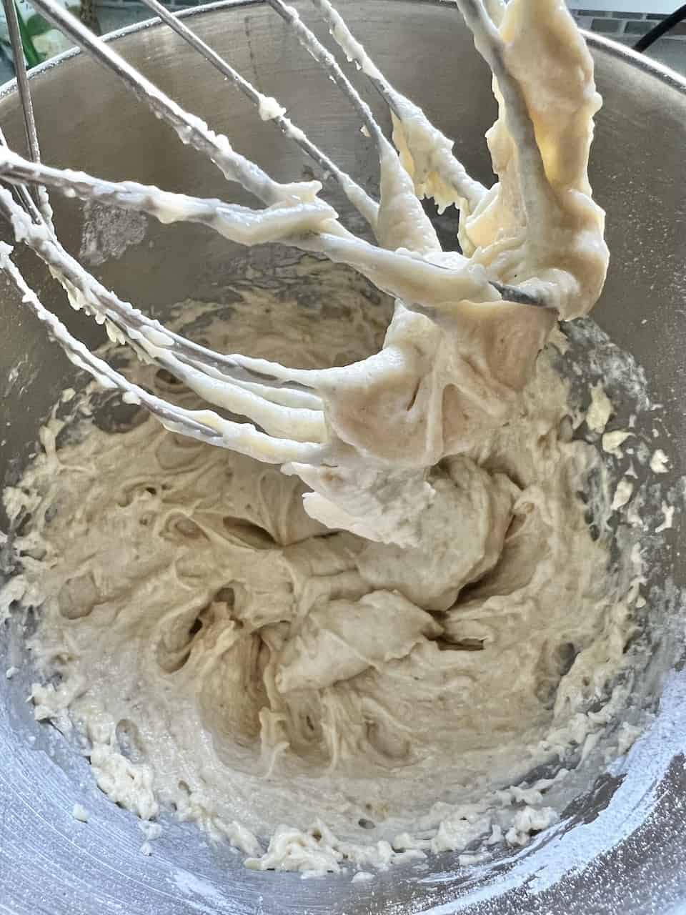 process of using whisk to mix ingredients in bowl
