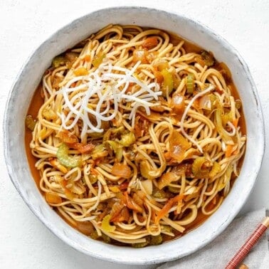 completed bowl of Veggie Chow Mein in a white bowl against a white background