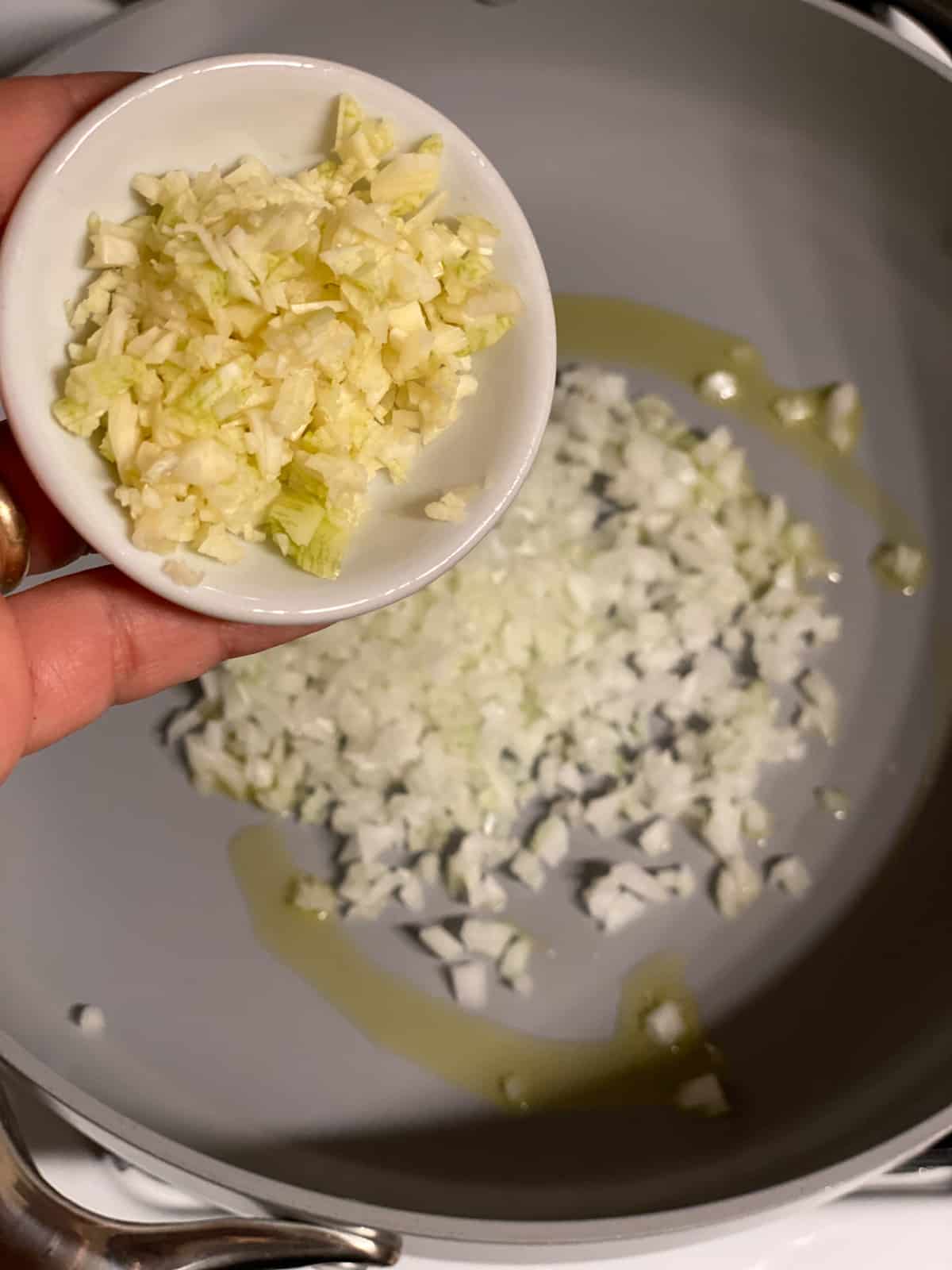 process of adding garlic to pan