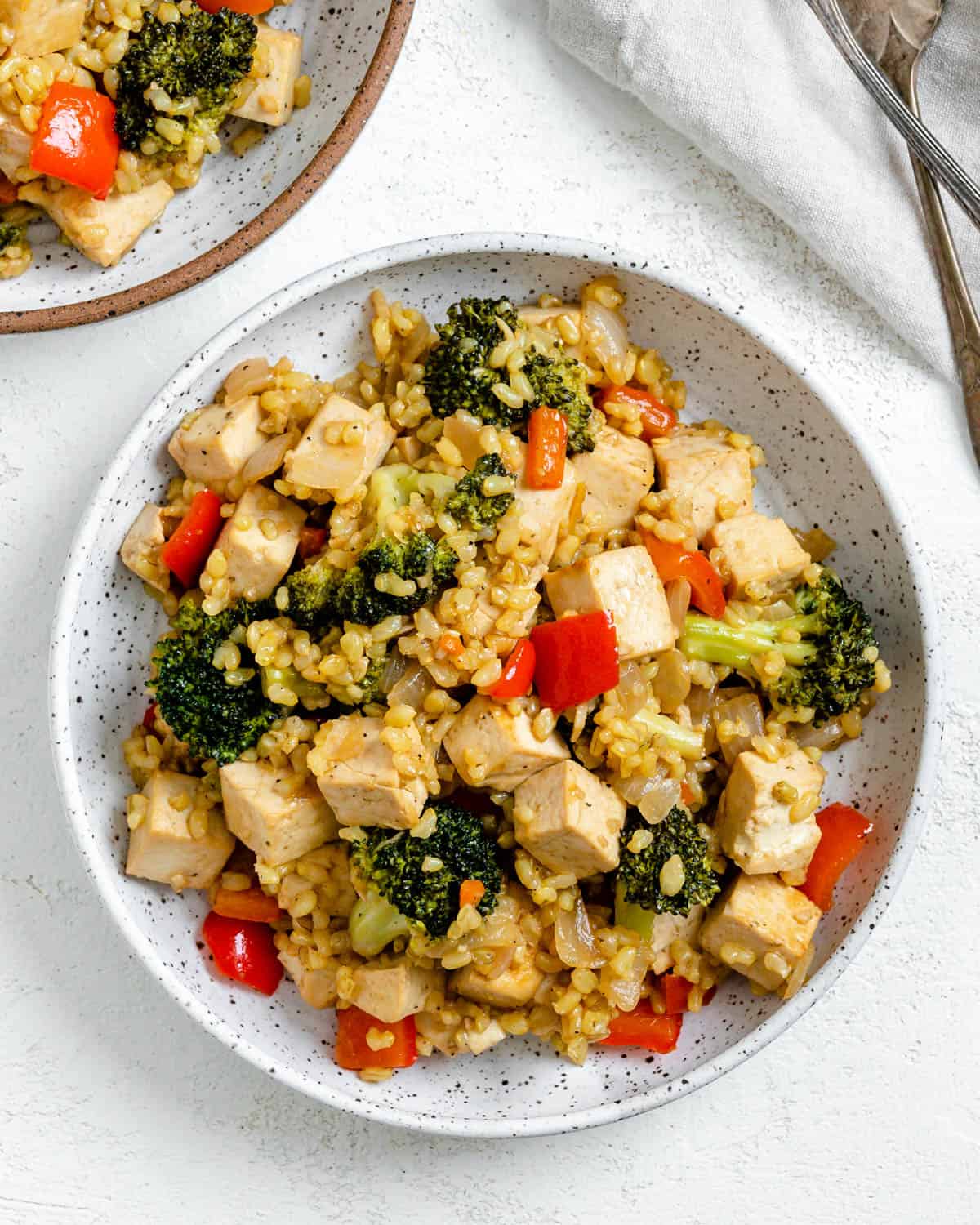 completed Veggie Brown Rice Stir Fry  in a bowl against a white background