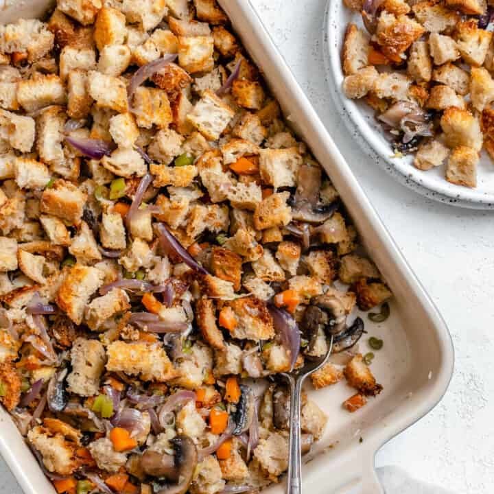 completed Easy Mushroom Stuffing Recipe in dish alongside a plated serving