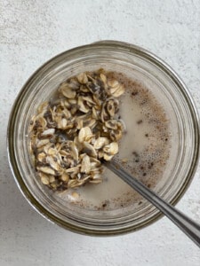process shot of mixing in oatmeal in glass jar