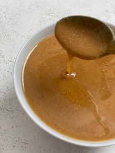 process shot of mixing caramel ingredients for Salted Caramel Overnight Oats in a bowl