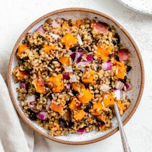 completed Sweet Potato Quinoa Bowl against a white surface
