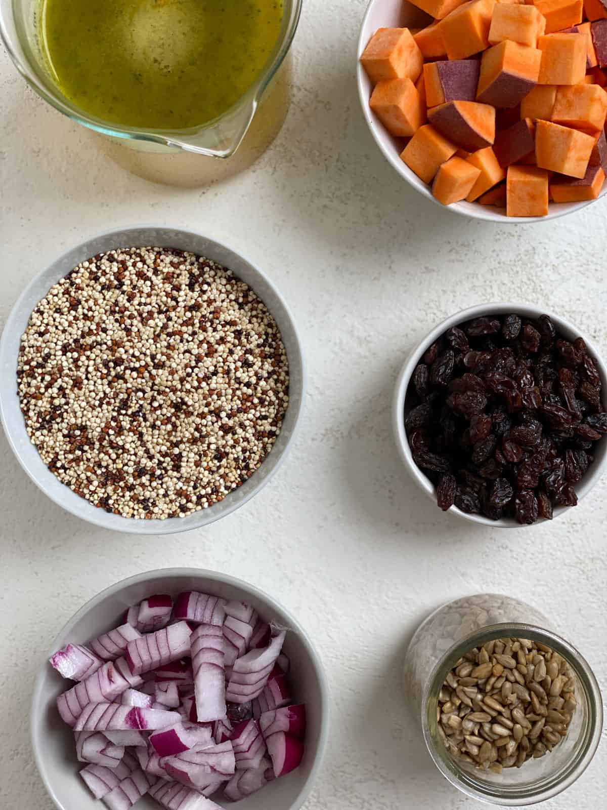 ingredients for Sweet Potato Quinoa Bowl measured out against a white surface