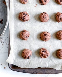 process of making Chocolate Peppermint Chocolate Chip Cookies with balls being placed on parchment paper
