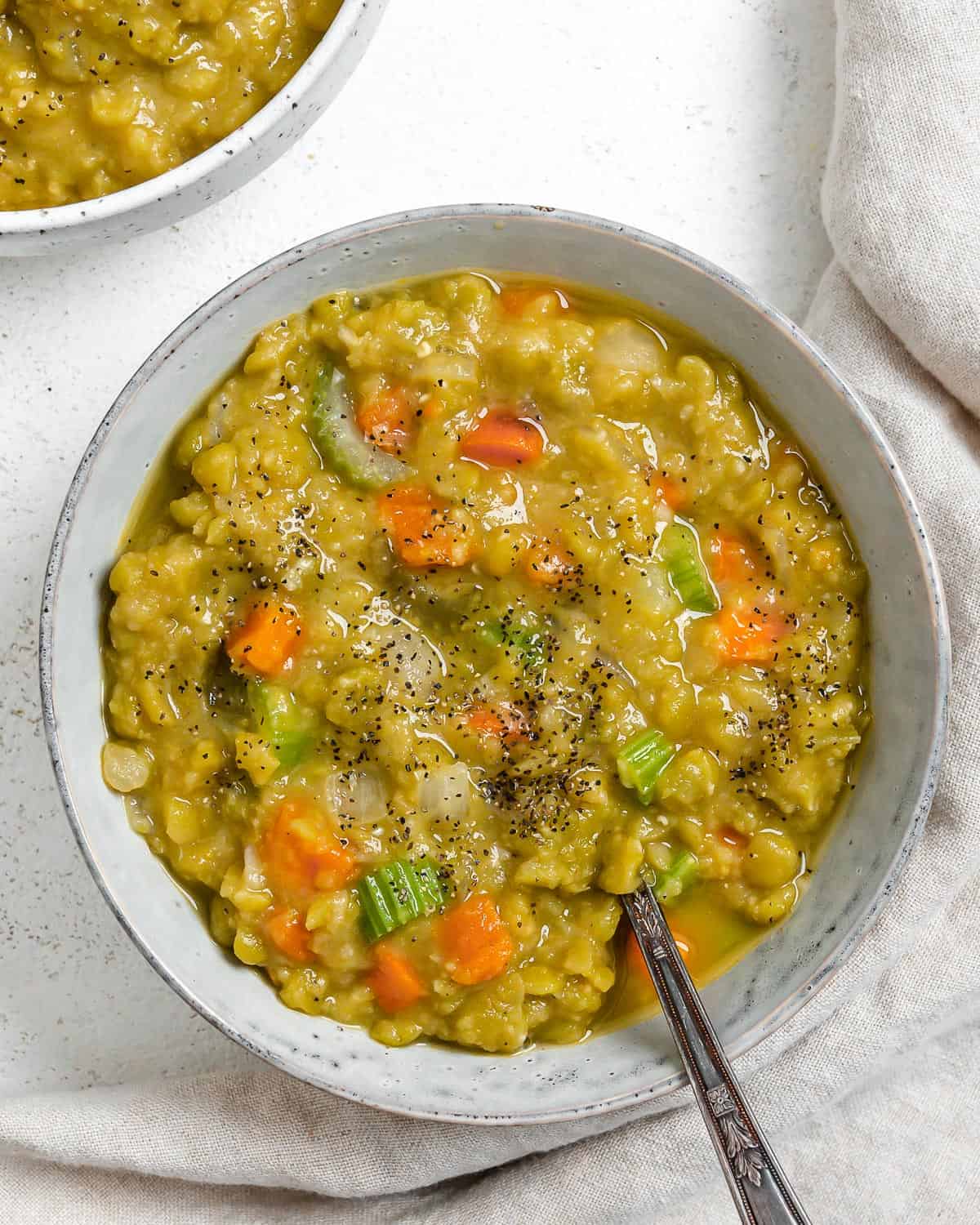 completed Vegan Split Pea Soup in a white bowl against a white surface
