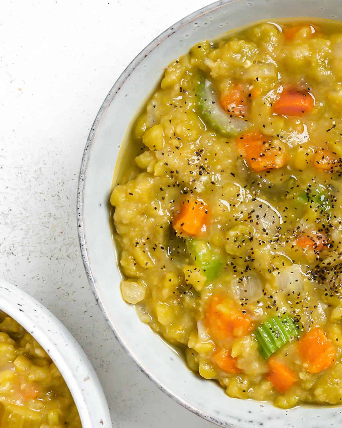 completed Vegan Split Pea Soup in a white bowl against a white surface