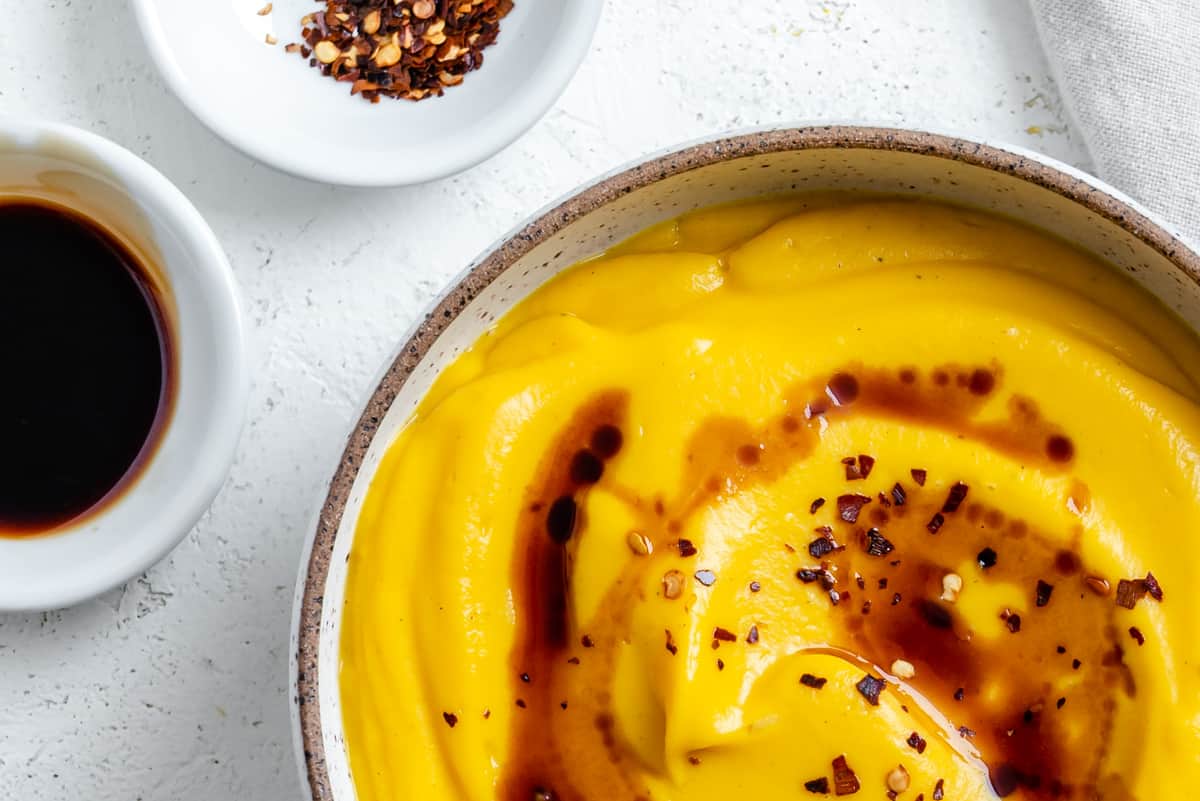 completed Easy Vegan Pumpkin Soup against a white surface