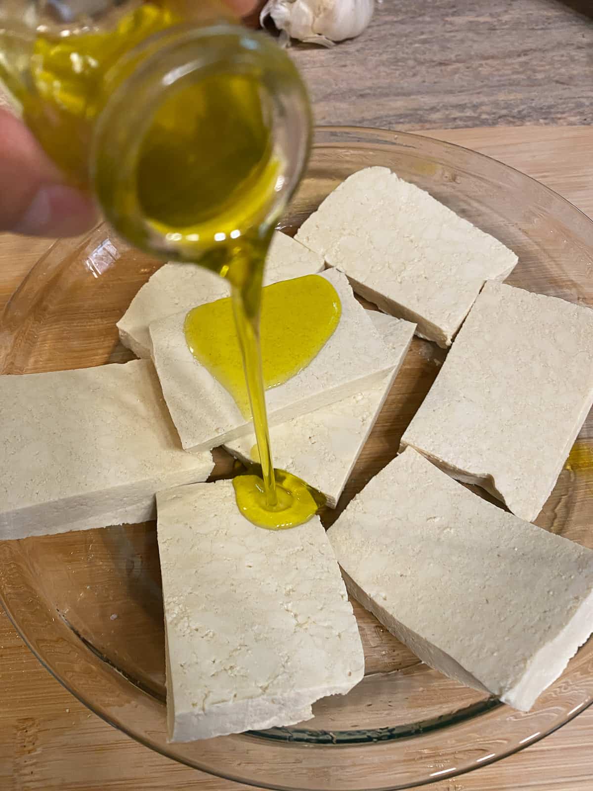 process of adding oil to blocks of tofu