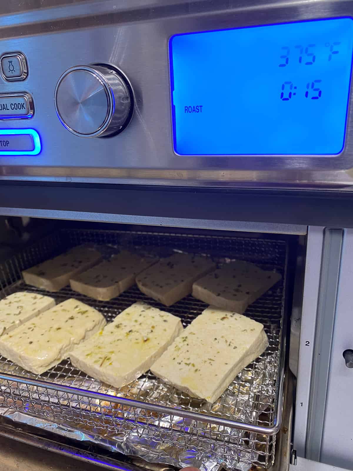 process of adding tofu slices to oven