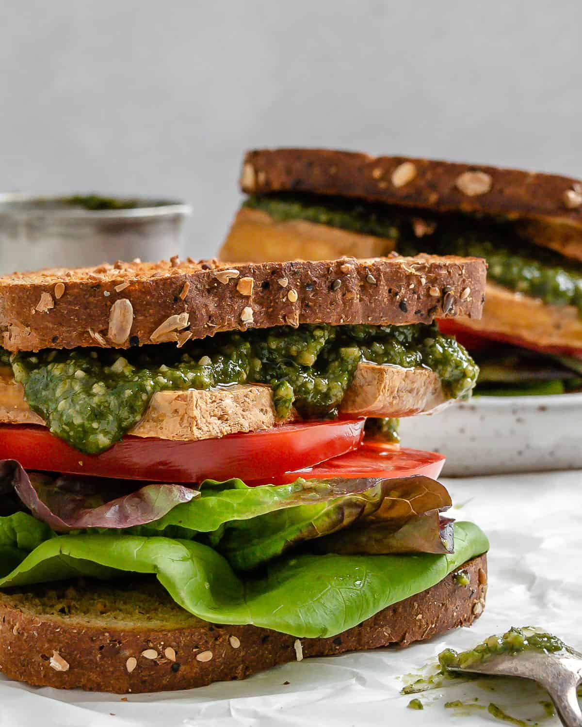 two completed Tofu and Pesto Sandwiches against a light surface