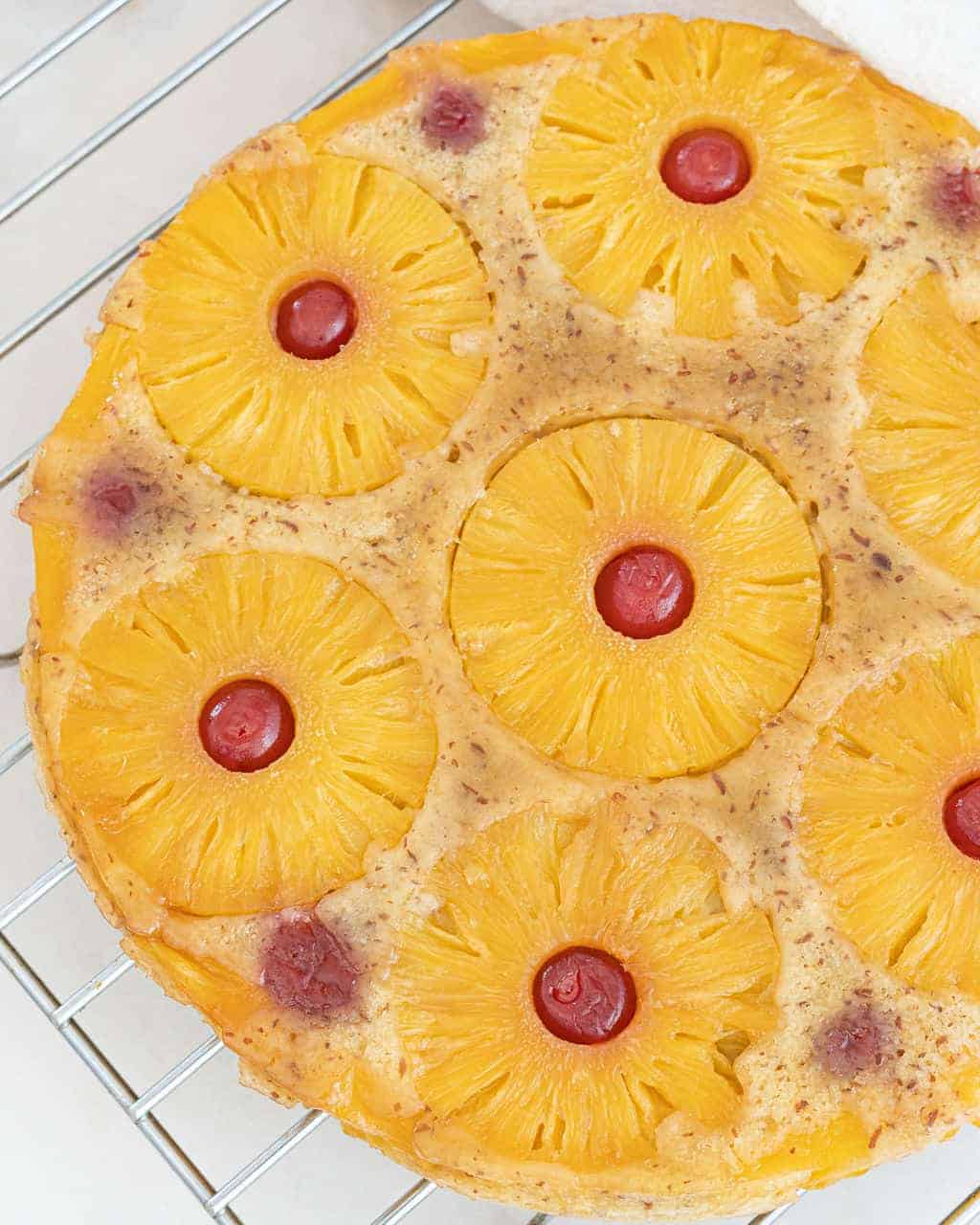 completed Vegan Pineapple Upside Down Cake against a white surface