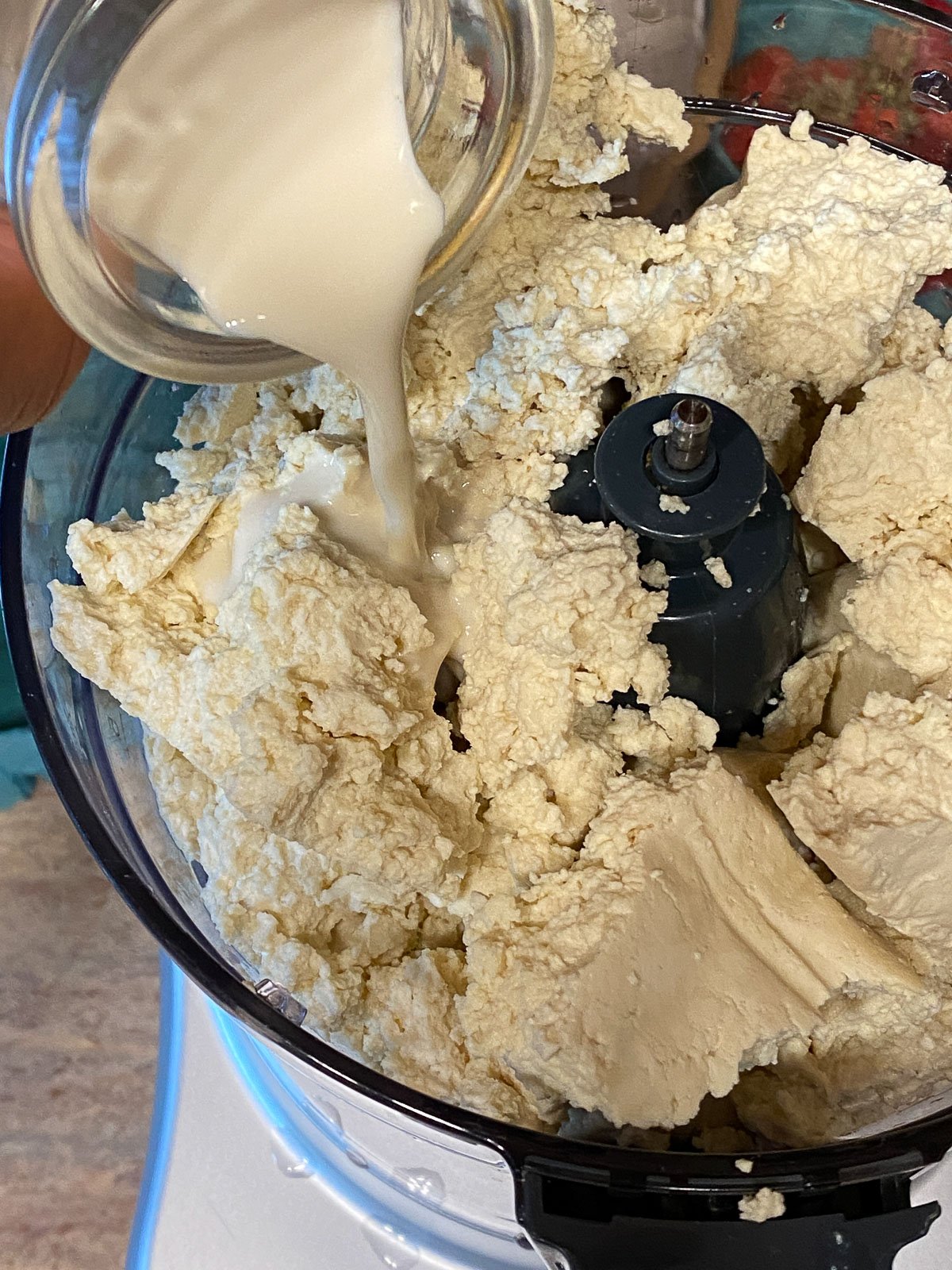 process of adding soy milk to food processor