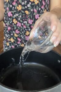 process of pouring water into pot