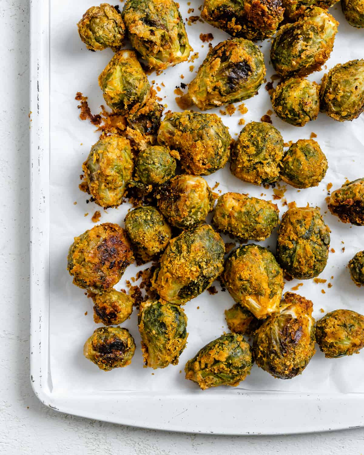 completed Easy Vegan Brussels Sprouts scattered on a white surface