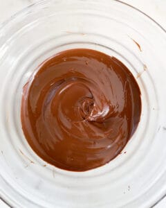 melted chocolate in clear bowl against white surface