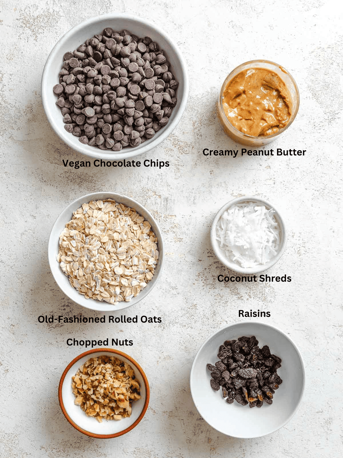 Ingredients for Chocolate Covered Peanut Butter Balls measured out on a white surface. 