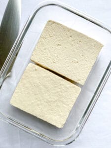 two blocks of tofu in a baking dish