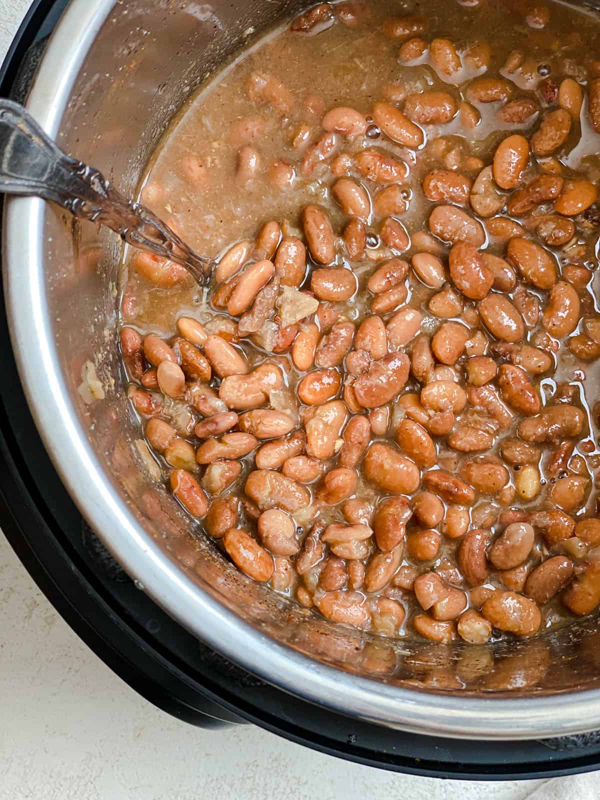 process shot of stirring ingredients in Instant Pot Pinto Beans