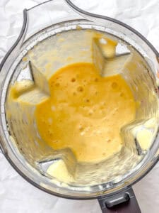 process shot showing ingredients in blender post being blended