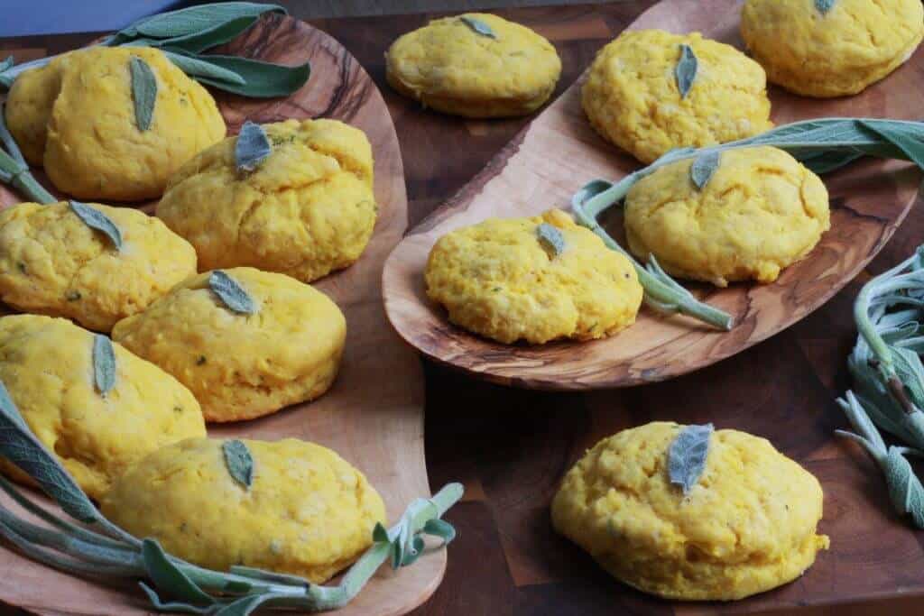 Butternut squash biscuits with a sage leaf pressed into the top of each one.