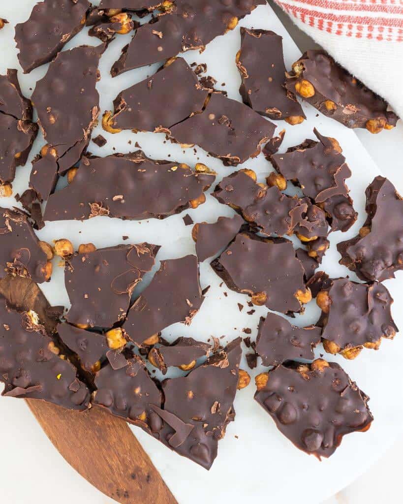 finished chocolate Chickpea Bark spread out against a white cutting board