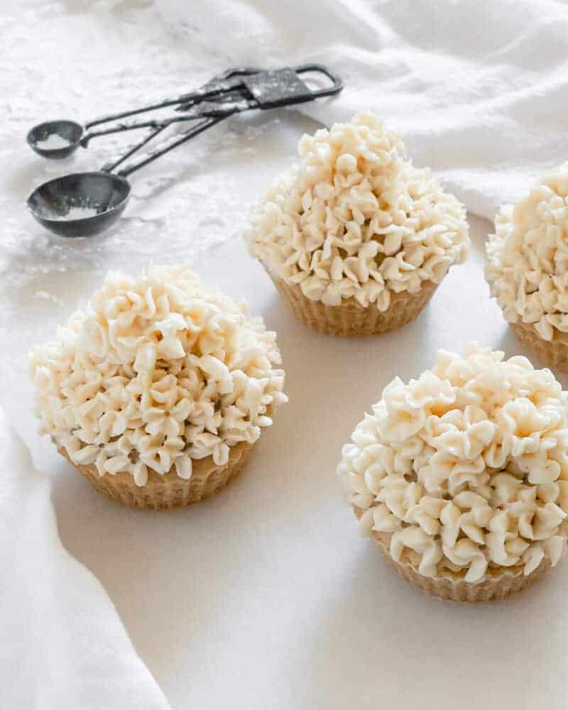 Vegan buttercream showcased on vanilla cupcakes.
